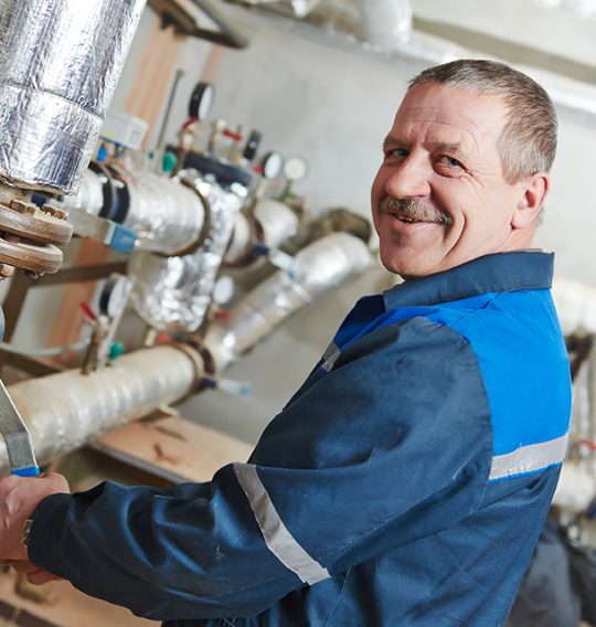 repairman engineer of fire engineering system or heating system open the valve equipment in a boiler house